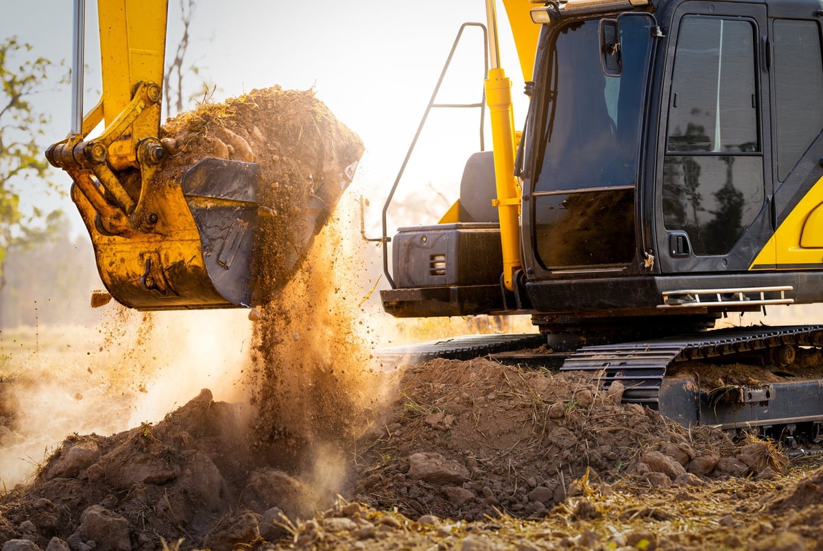 Excavator digging soil for earthworks