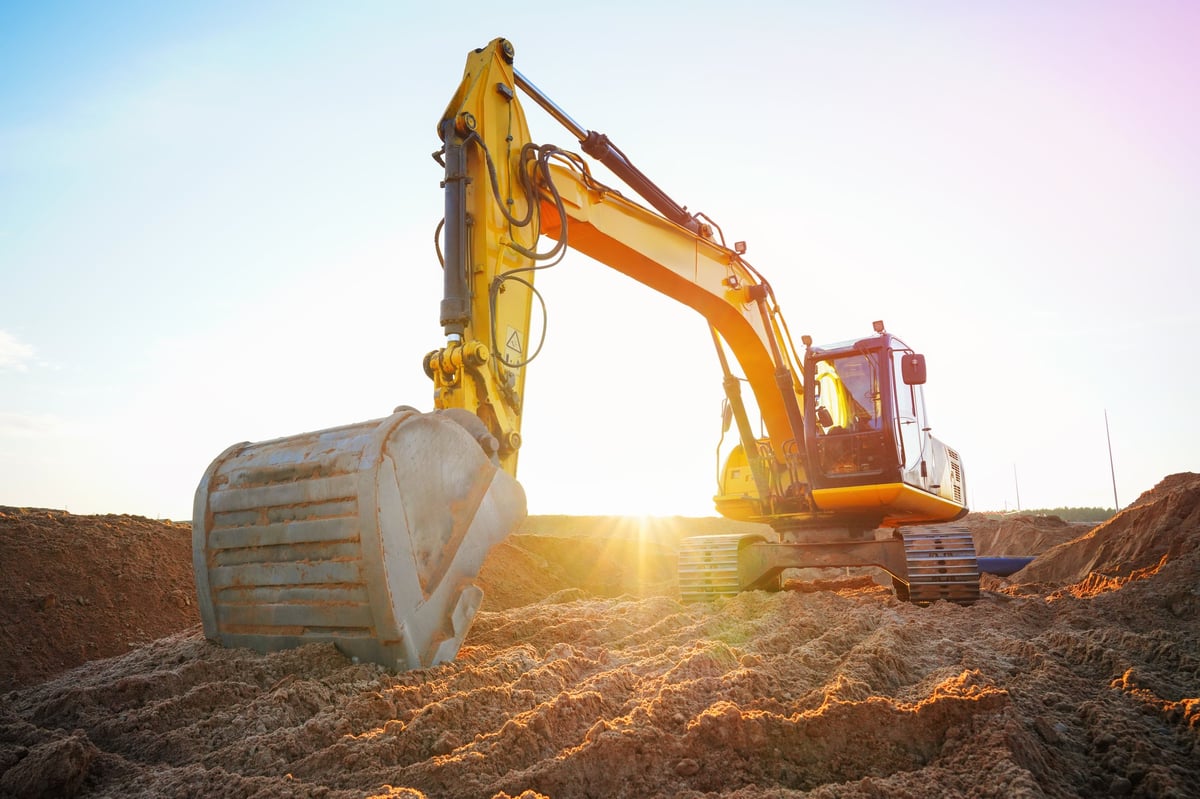 Excavator moving soil at a construction site